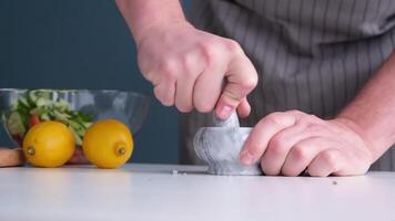 man making seasoning in the mortar video
