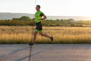 Triathlete in professional gear running early in the morning, preparing for a marathon, dedication to sport and readiness to take on the challenges of a marathon. photo