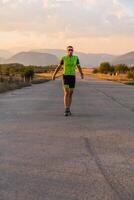 Triathlete in professional gear running early in the morning, preparing for a marathon, dedication to sport and readiness to take on the challenges of a marathon. photo