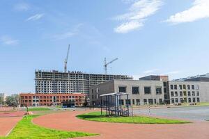 A Playground against the background of construction projects in a new residential area photo