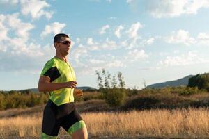 Triathlete in professional gear running early in the morning, preparing for a marathon, dedication to sport and readiness to take on the challenges of a marathon. photo