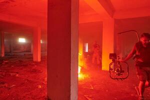 A professional cameraman captures the intense moments as a group of skilled soldiers embarks on a dangerous mission inside an abandoned building, their actions filled with suspense and bravery photo