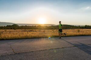 Triathlete in professional gear running early in the morning, preparing for a marathon, dedication to sport and readiness to take on the challenges of a marathon. photo