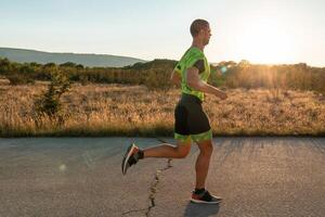 Triathlete in professional gear running early in the morning, preparing for a marathon, dedication to sport and readiness to take on the challenges of a marathon. photo