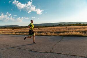 Triathlete in professional gear running early in the morning, preparing for a marathon, dedication to sport and readiness to take on the challenges of a marathon. photo