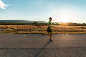 Triathlete in professional gear running early in the morning, preparing for a marathon, dedication to sport and readiness to take on the challenges of a marathon. photo
