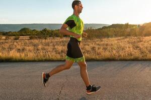 Triathlete in professional gear running early in the morning, preparing for a marathon, dedication to sport and readiness to take on the challenges of a marathon. photo