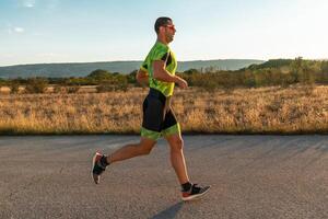 Triathlete in professional gear running early in the morning, preparing for a marathon, dedication to sport and readiness to take on the challenges of a marathon. photo