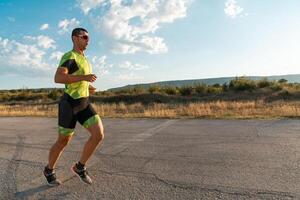 Triathlete in professional gear running early in the morning, preparing for a marathon, dedication to sport and readiness to take on the challenges of a marathon. photo