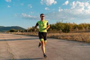 Triathlete in professional gear running early in the morning, preparing for a marathon, dedication to sport and readiness to take on the challenges of a marathon. photo