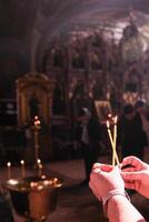 A person is holding a candle in their hand photo