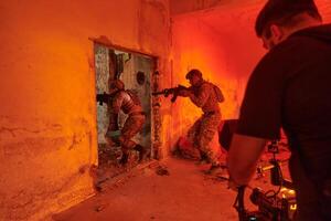 A professional cameraman captures the intense moments as a group of skilled soldiers embarks on a dangerous mission inside an abandoned building, their actions filled with suspense and bravery photo