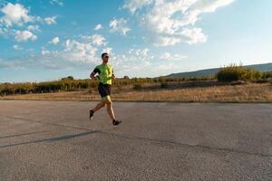 Triathlete in professional gear running early in the morning, preparing for a marathon, dedication to sport and readiness to take on the challenges of a marathon. photo