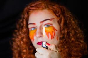 Portrait of girl with a fiery make-up photo