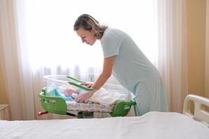 Newborn baby sleeping on a blanket in clinic Age 1 week photo