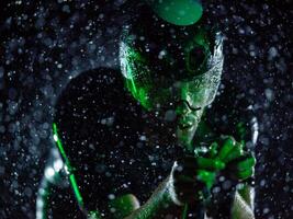 A triathlete braving the rain as he cycles through the night, preparing himself for the upcoming marathon photo