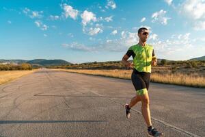 Triathlete in professional gear running early in the morning, preparing for a marathon, dedication to sport and readiness to take on the challenges of a marathon. photo