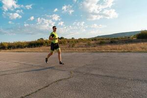 Triathlete in professional gear running early in the morning, preparing for a marathon, dedication to sport and readiness to take on the challenges of a marathon. photo