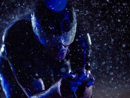 A triathlete braving the rain as he cycles through the night, preparing himself for the upcoming marathon. The blurred raindrops in the foreground and the dark, moody atmosphere in the background add photo