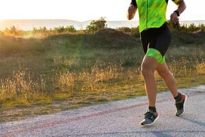 Triathlete in professional gear running early in the morning, preparing for a marathon, dedication to sport and readiness to take on the challenges of a marathon. photo
