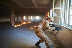 A professional soldier carries out a dangerous military mission in an abandoned building photo