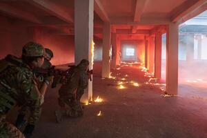 A professional cameraman captures the intense moments as a group of skilled soldiers embarks on a dangerous mission inside an abandoned building, their actions filled with suspense and bravery photo