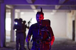 A professional cameraman captures the intense moments as a group of skilled soldiers embarks on a dangerous mission inside an abandoned building, their actions filled with suspense and bravery photo