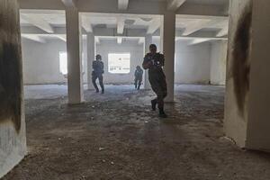 A professional cameraman captures the intense moments as a group of skilled soldiers embarks on a dangerous mission inside an abandoned building, their actions filled with suspense and bravery photo