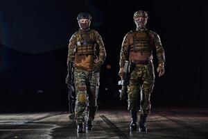 Two professional soldiers marching through the dark of night on a dangerous mission, epitomizing their unwavering bravery, unwavering teamwork, and the high-stakes intensity of their specialized photo