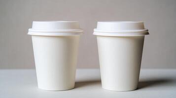 Two white disposable coffee cups on neutral background photo