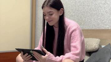 Girl using tablet on bed, changing facial expressions video