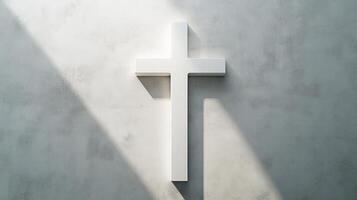 Minimalist white cross on concrete wall with sunlight shadows photo