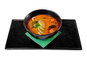 Soup tom yum with seashells and mussels top view on white background photo