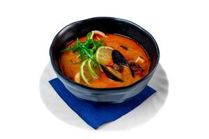 Soup tom yum with seashells and mussels side view on white background photo