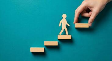 Hand reaching for wooden man on stairs photo