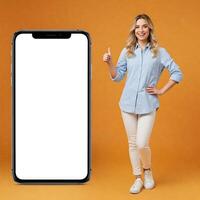 A woman standing next to a phone with a blank screen photo
