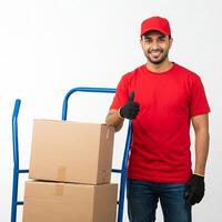 A man in a red shirt and hat holding a cart with boxes photo