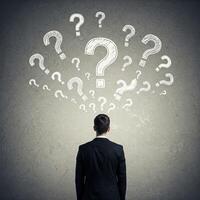 Businessman with question marks on head looking at question marks concept reklamn fot photo