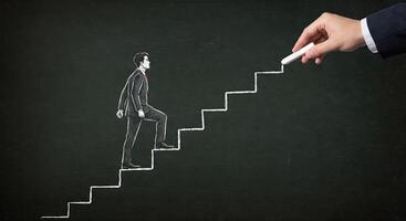 Businessman climbing stairs to success concept photo