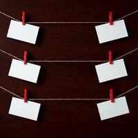 Four blank business cards hanging on a rope photo