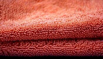 Soft Texture of an Orange Towel Folded Neatly on a Dark Surface in a Cozy Indoor Setting photo