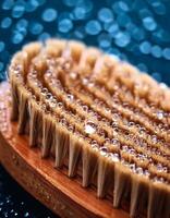 Close-up of a Brush With Water Droplets on Bristles Against a Blurred Blue Background in a Wet Environment photo