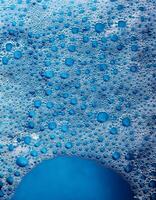 Bubbles Create a Mesmerizing Pattern in Bright Blue Water During a Refreshing Summer Day photo
