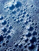 Close-up of Blue Bubbles Creating Intricate Patterns in Liquid photo