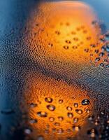 Close-up of Raindrops on Glass With Warm Light Glowing in the Background During a Rainy Evening photo