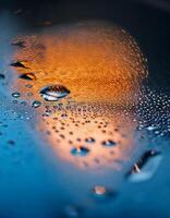Raindrops Glisten on a Surface Reflecting Warm Light During a Peaceful Evening photo