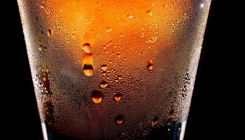 Refreshing Beverage With Condensation in a Clear Glass Illuminated by Soft Light Showcasing Vibrant Colors photo