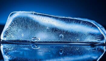 Close-up View of a Crystal-Clear Ice Block on Glossy Surface Reflecting Blue Light in a Cool Setting photo
