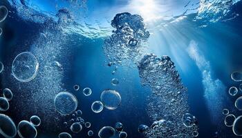 Underwater Bubbles Rise Towards the Surface as Sunlight Filters Through the Deep Blue Ocean photo