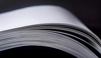 Close-up View of Open Blank Book Pages Showing Fine Details of Paper Texture in Low Light Setting photo